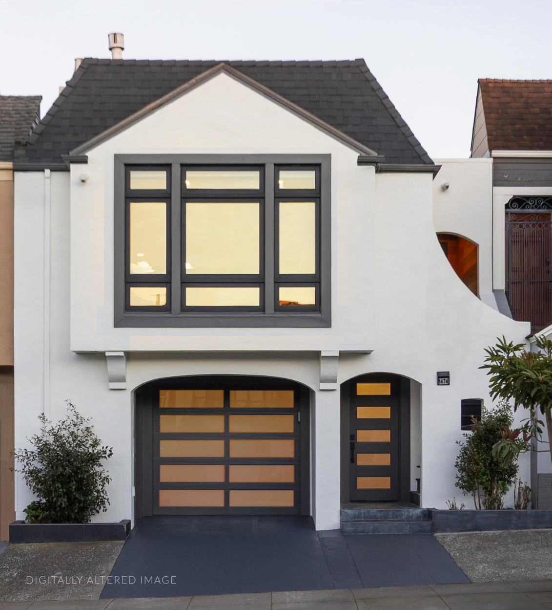 Modern two-story house with white exterior, black-framed windows, black front door with horizontal glass panels, and a black garage door with horizontal glass panes. Small front garden with bushes and a paved driveway.