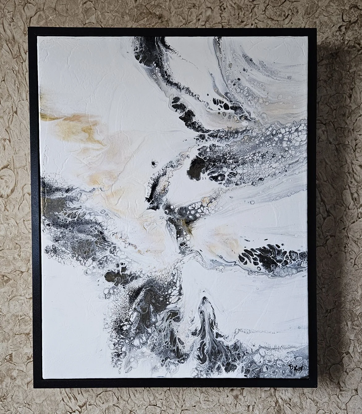 Abstract black, white, and beige acrylic pour painting with swirling patterns and cellular structures, framed in black.