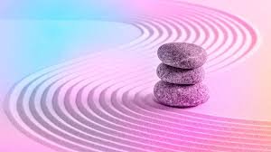 Three round grey stones stacked on a colorful striped background.