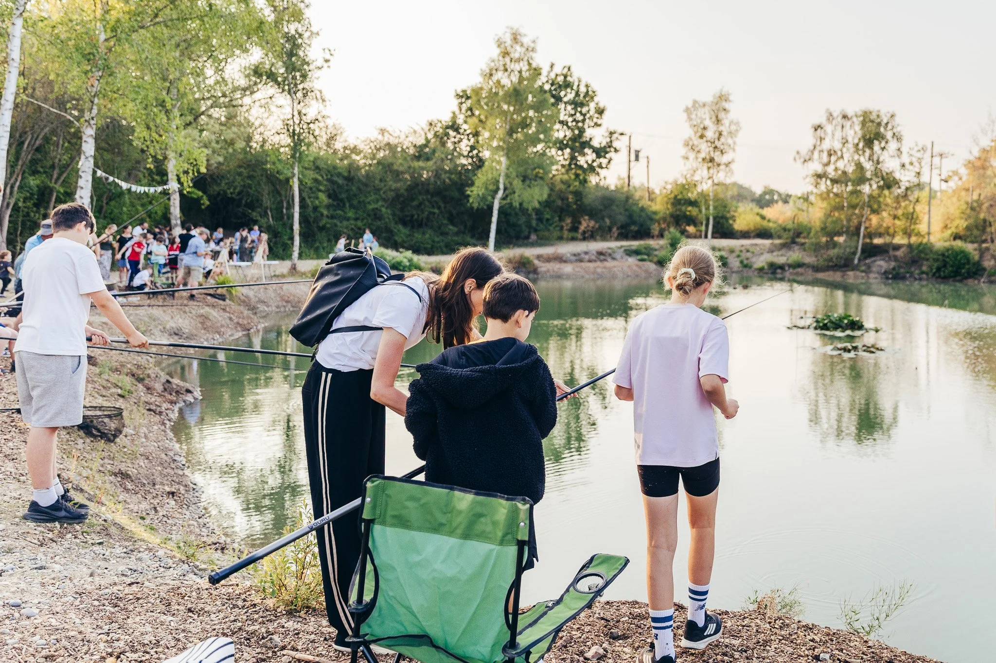 Families and educators connecting during an alternative education provision open evening in Essex, photographed in a natural documentary style.