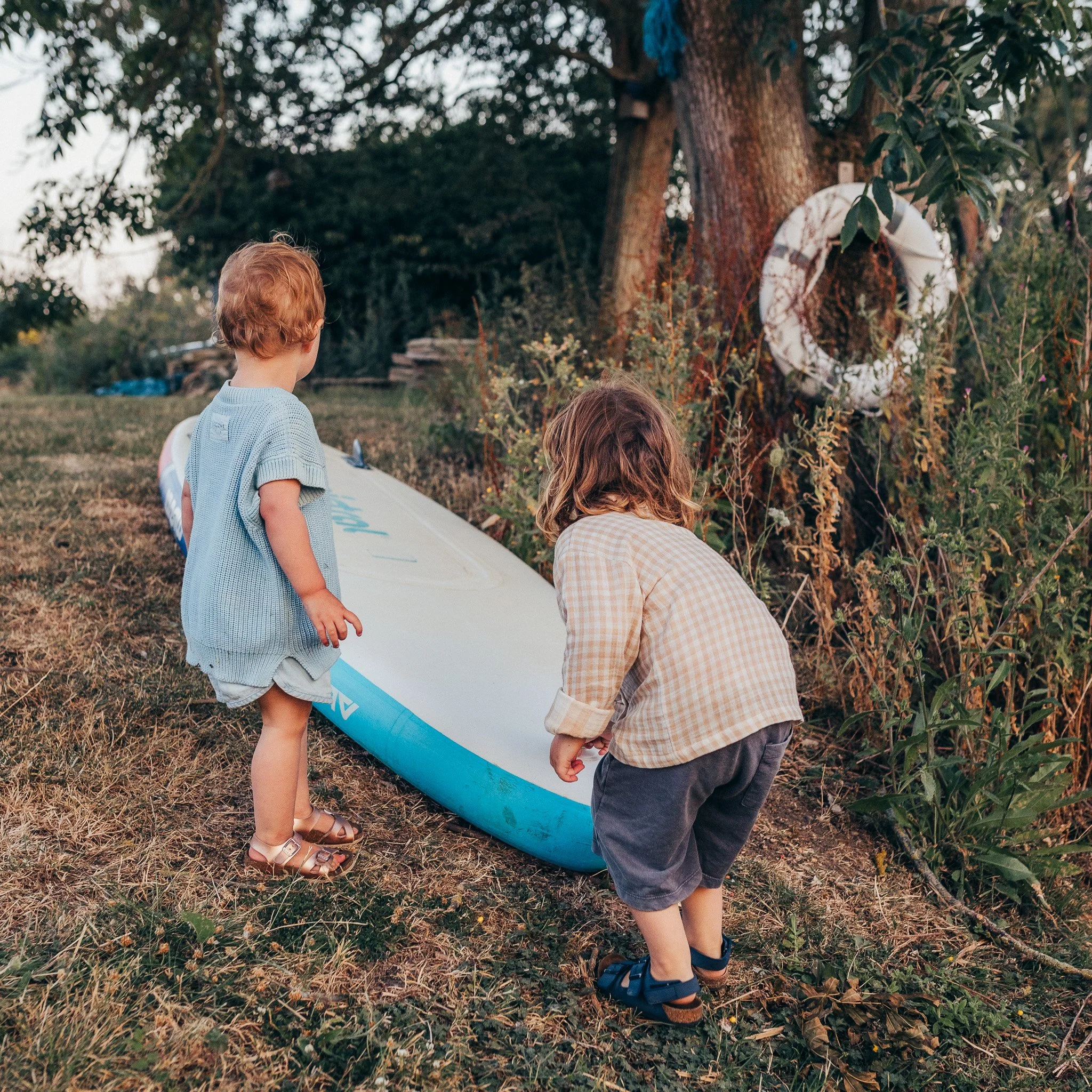 Siblings playing together with a raft at home.