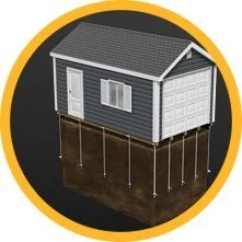 A small gray house with a gabled roof on stilts, set against a circular black background with a yellow border.
