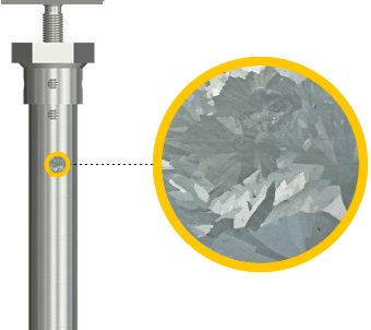 Close-up of a metal cylinder with a yellow handle and a magnified view of crumpled aluminum foil.