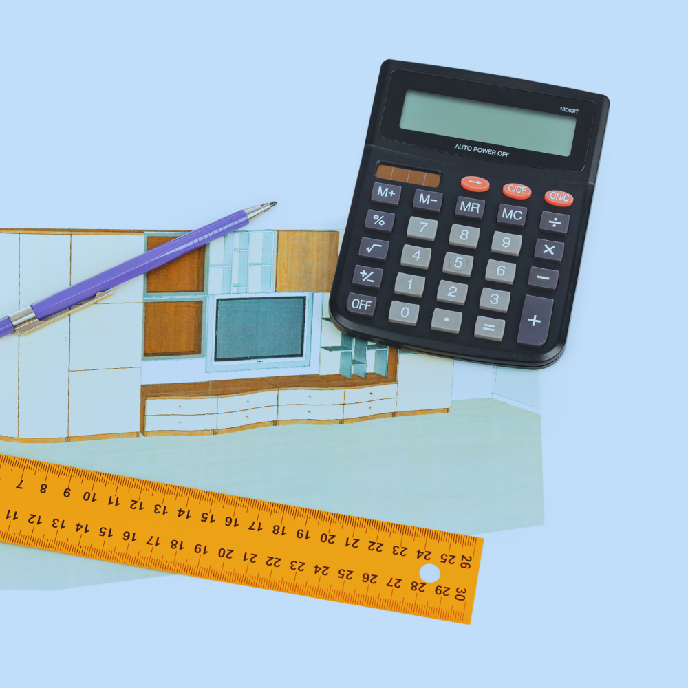A calculator, a purple pen, an orange ruler, and a drawing of a building on paper.