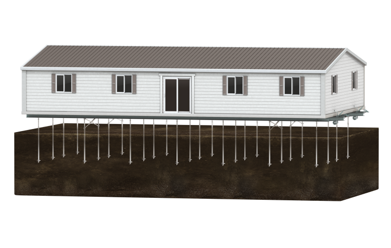 A house on stilts with a sloped metal roof, built over a foundation with multiple support poles underground.
