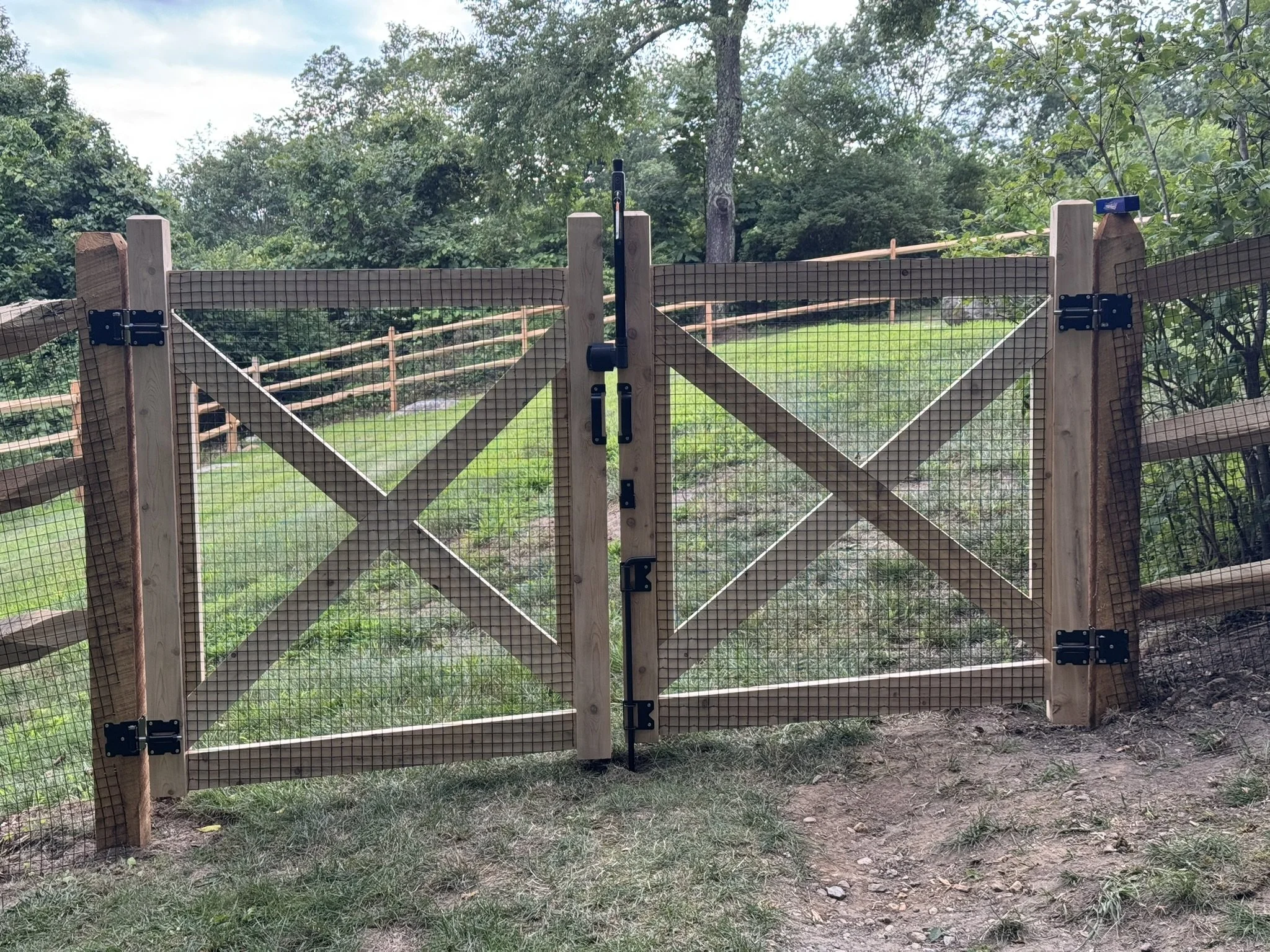 Racked Cedar post and rail gates built to grade in Morris CT