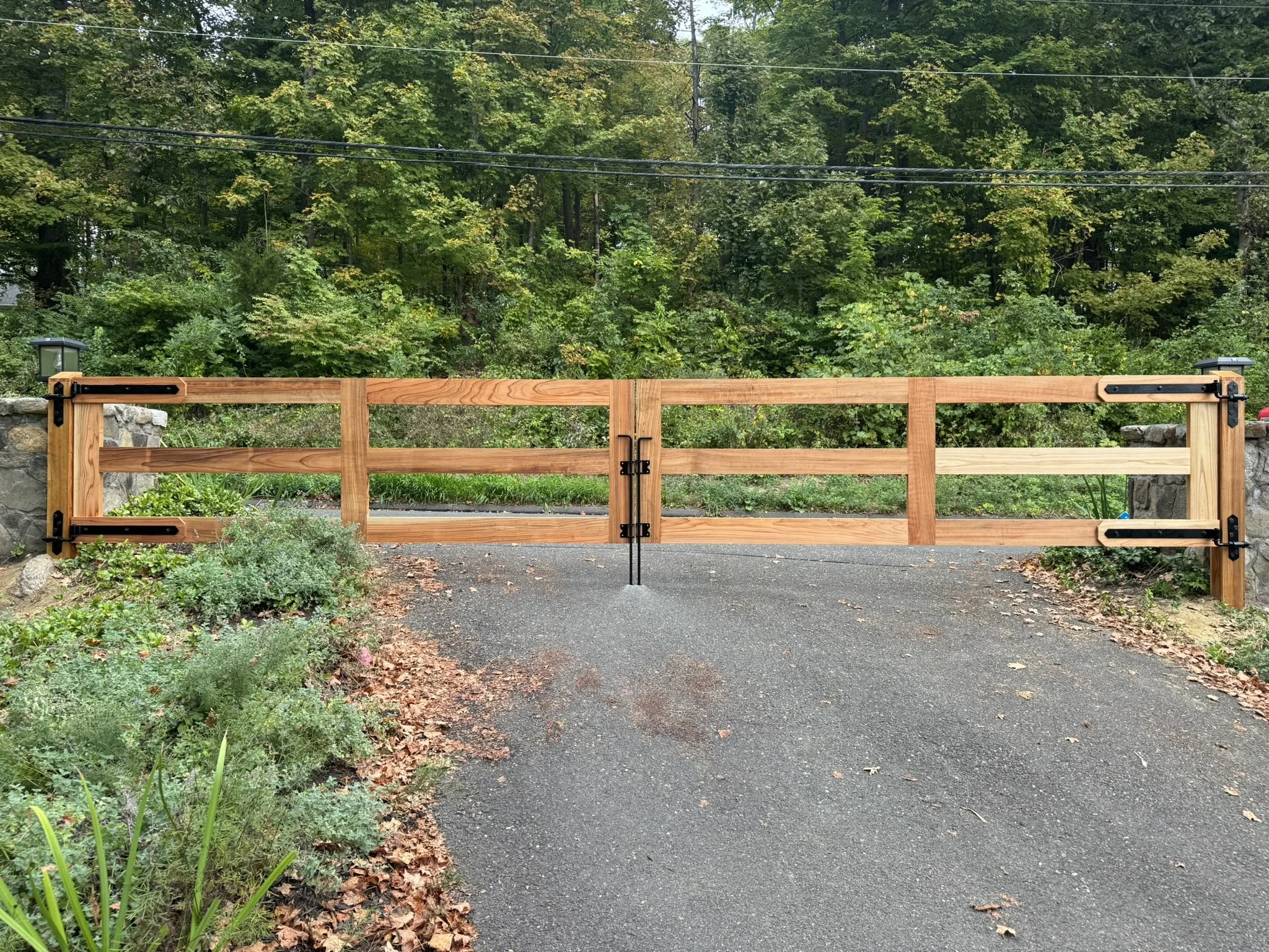 Custom clear red cedar driveway gates in Redding, CT.