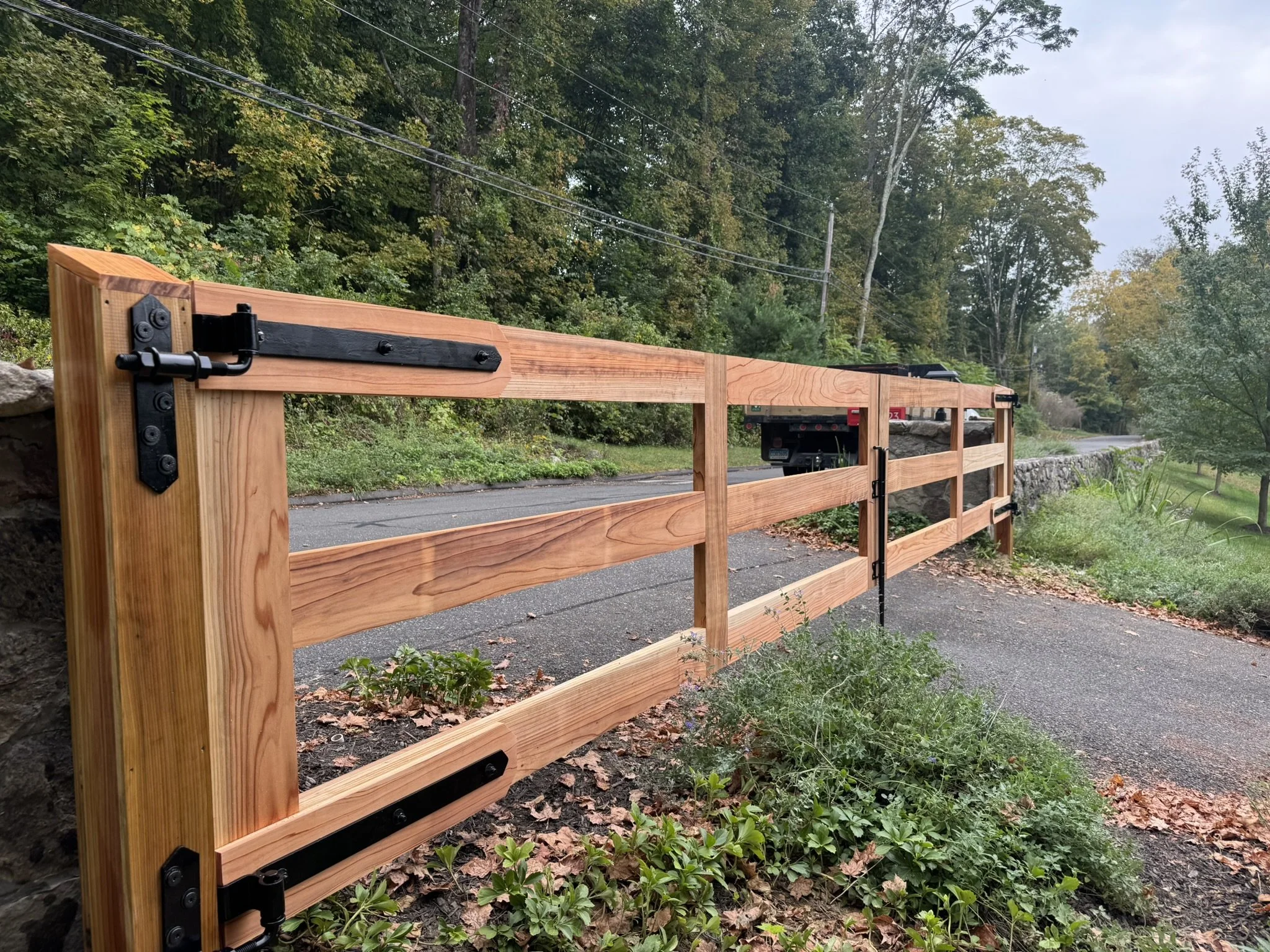 Custom clear red cedar driveway gates in Redding, CT.