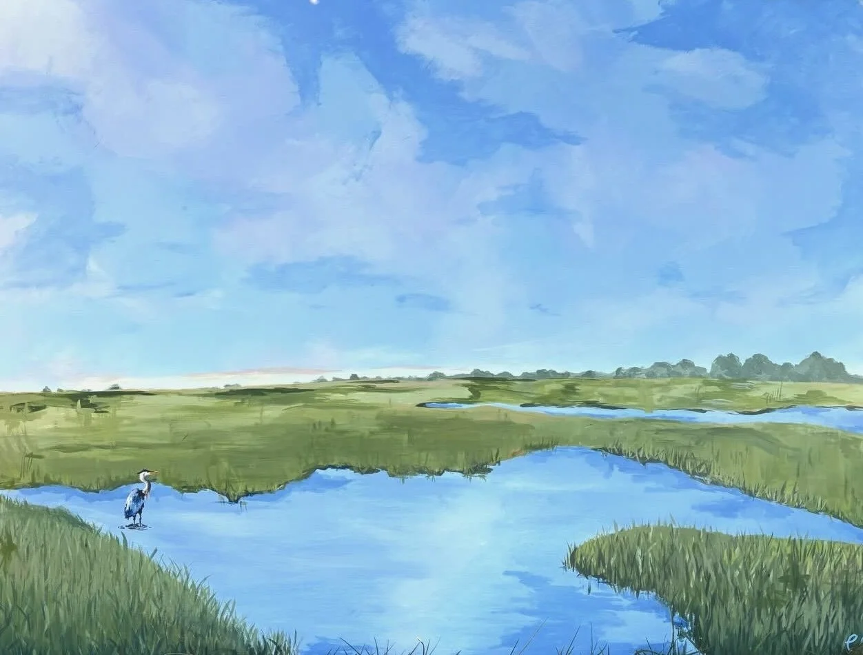 A watercolor painting of a peaceful marshland with blue water, tall green grass, a heron standing on the bank, and a bright blue sky with scattered clouds.