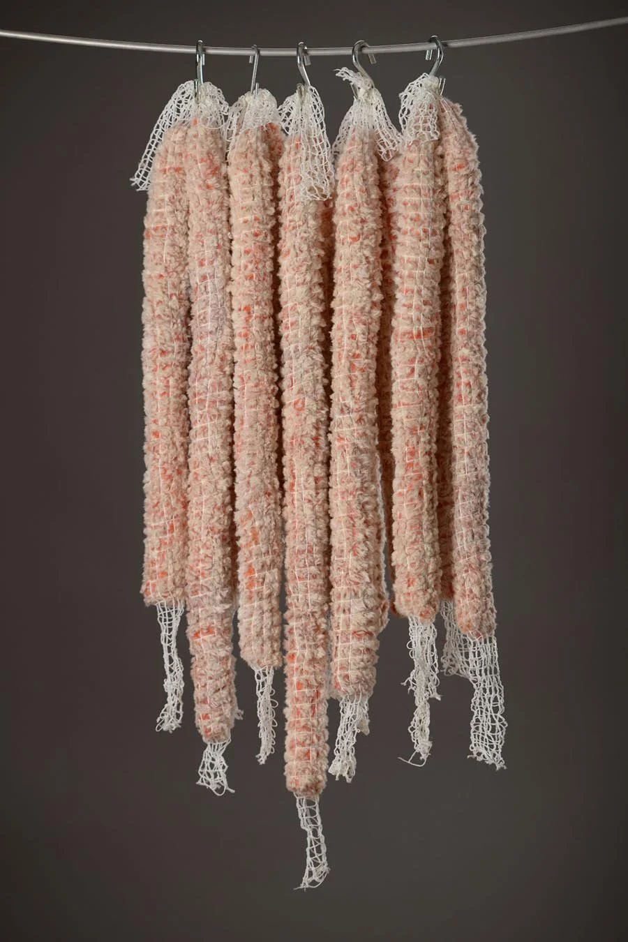 Rachel Major, Sausages, 2014, fabric, thread, polyester filling, netting, 2 x 24-32 ea 