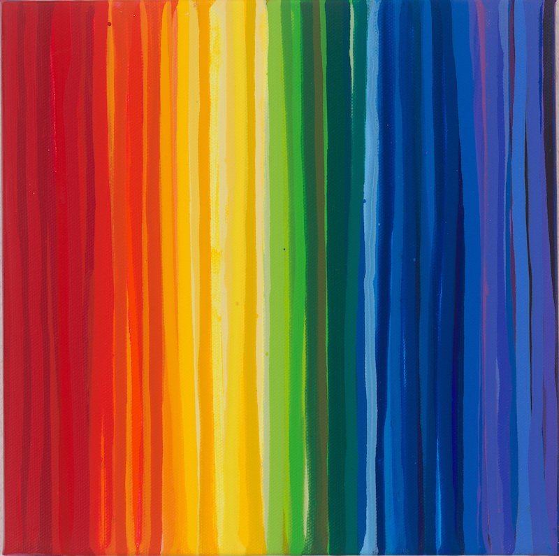 Rainbow colors painted vertically on a surface, transitioning from red on the left to blue on the right.