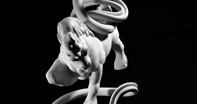 Close-up of a white sculpture of a muscular horse figure with a bold curving shape encircling it on a black background.