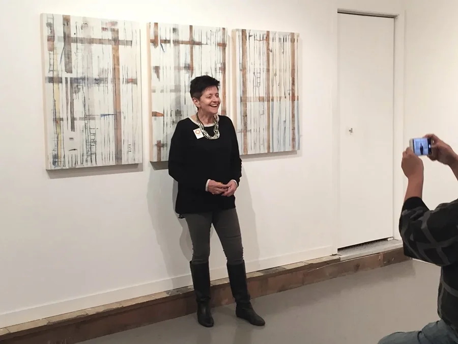 woman in front of a painting