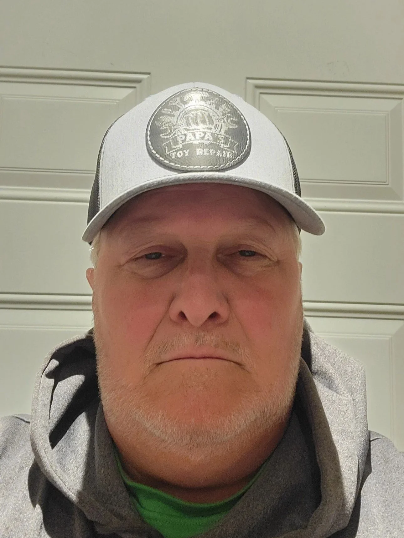 A rural landscape at sunset featuring green fields, a pond, a small building, and a sky with scattered clouds.