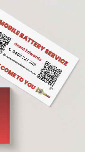 Business card for mobile battery service with contact info, QR code, and cartoon battery character.