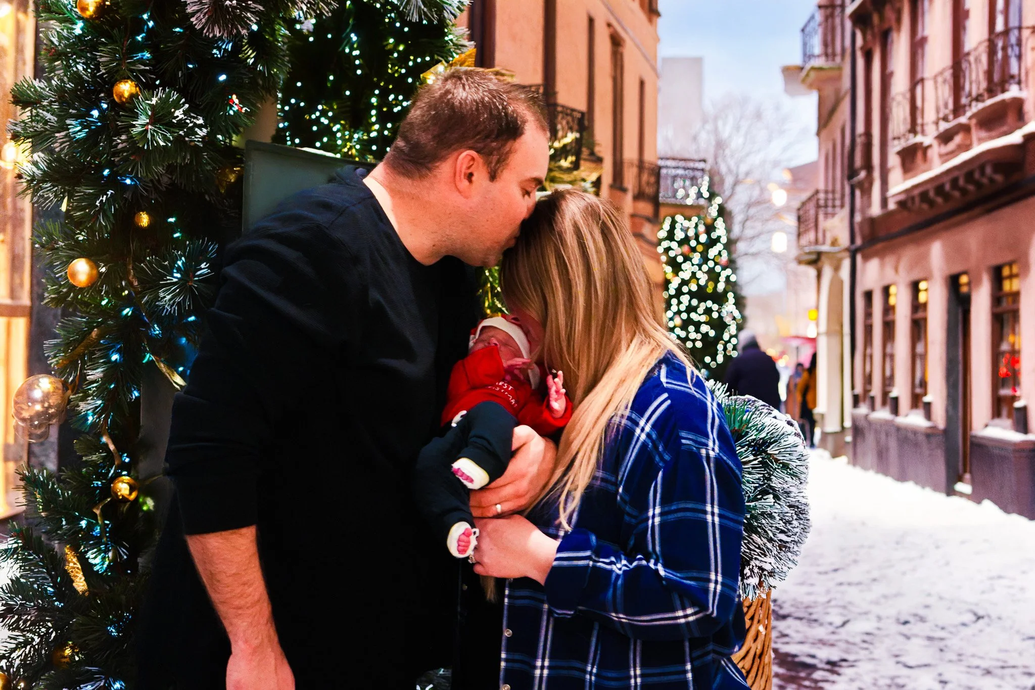 Warm, cozy Christmas family portrait featuring a smiling family in matching pajamas gathered around a decorated tree and fireplace. This holiday photo captures authentic joy, connection, and festive traditions perfect for seasonal cards and keepsakes