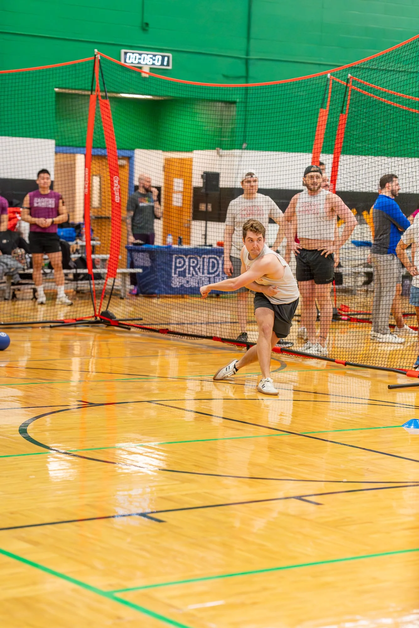 Man thows ball in dodgeball.  Club sports photography DFW.jpg