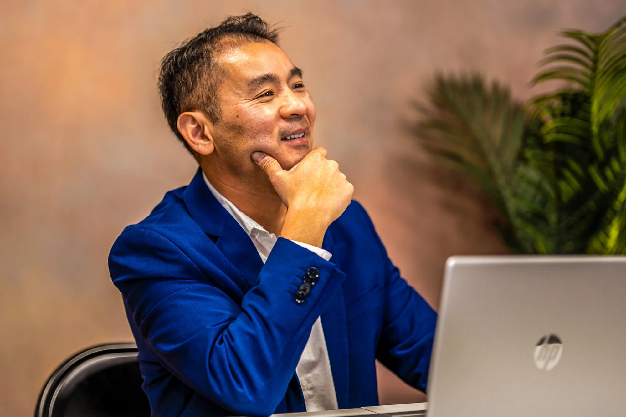 Professional headshot photography in Dallas, TX featuring a businessman in a blue suit. Executive portraits for LinkedIn, corporate profiles & business branding. Book your session today