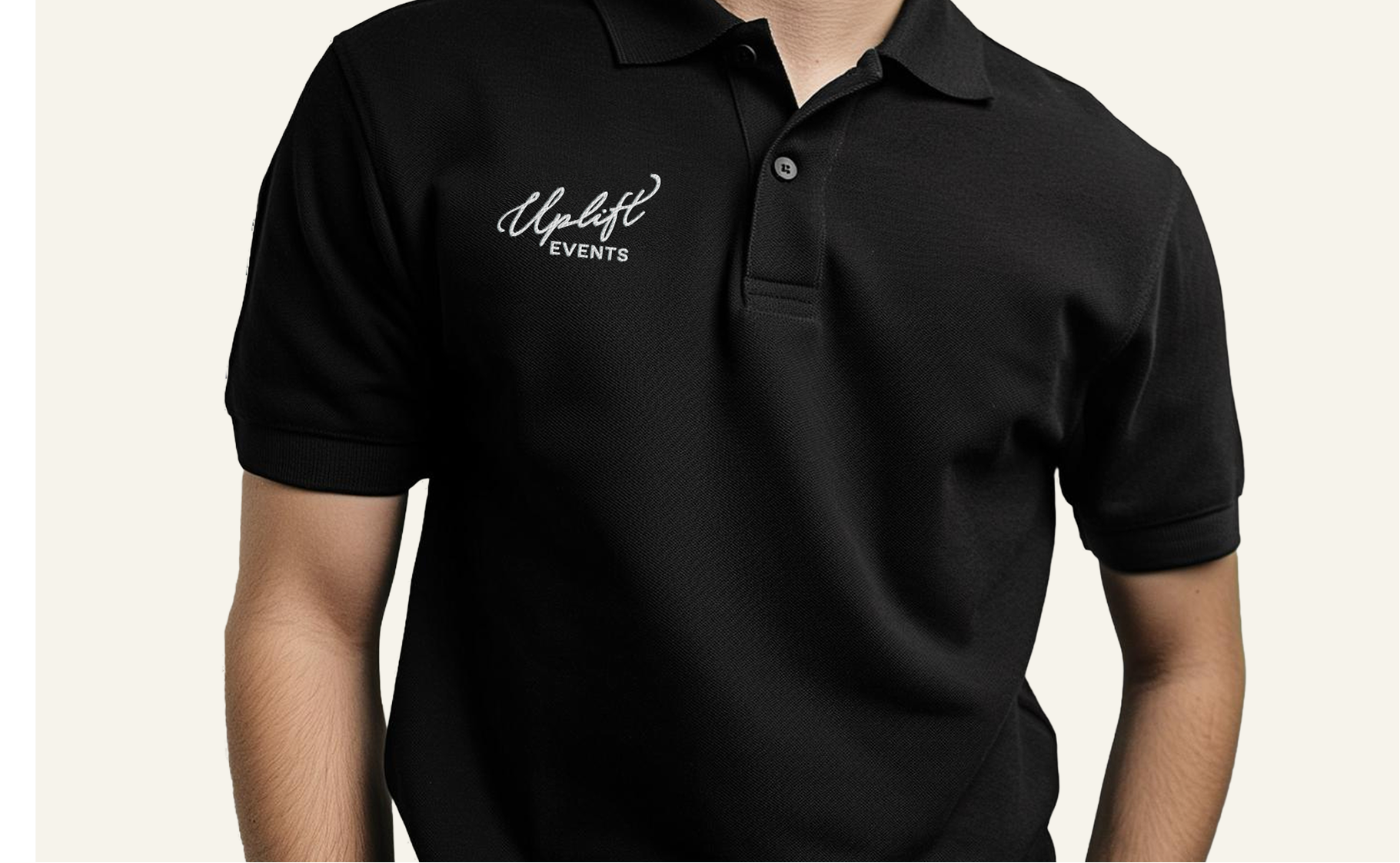 Close-up of a man wearing a black polo shirt with 'Uplift Events' embroidered on the left chest.