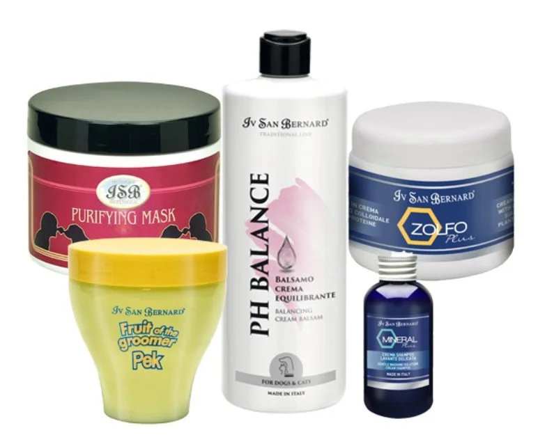 Collection of five pet grooming products including a purifying mask, balancing cream, foot cream, fruit of the groomer Pek, and mineral supplement in bottles and jars.