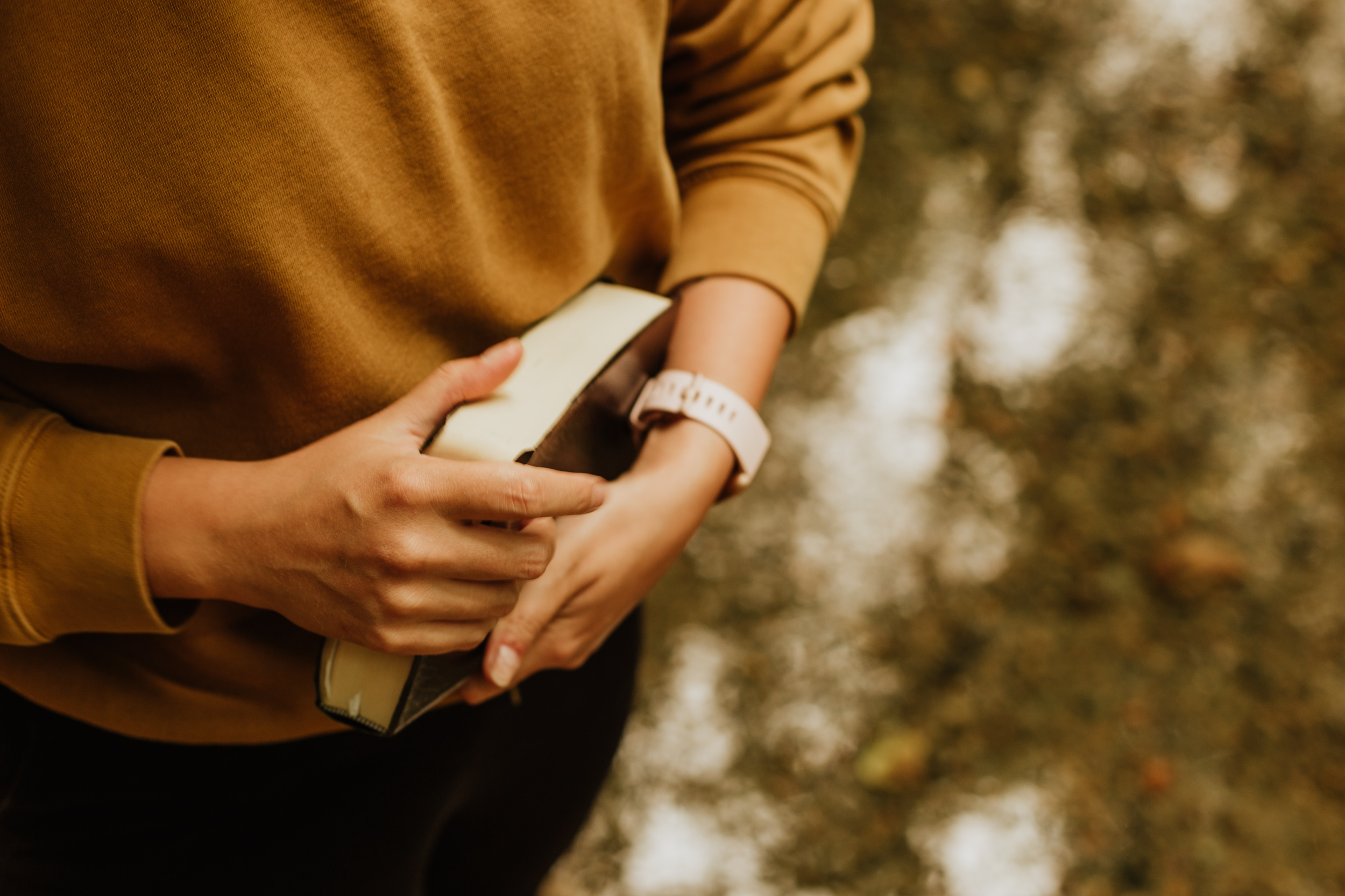 Person holding a book or journal outdoors in autumn