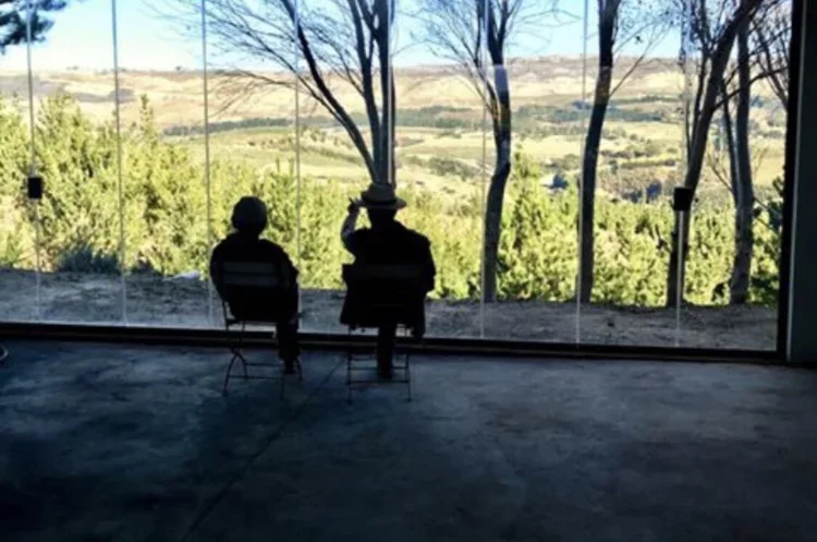 Two guests enjoying the views across Oneiric from within the cellar and events space.