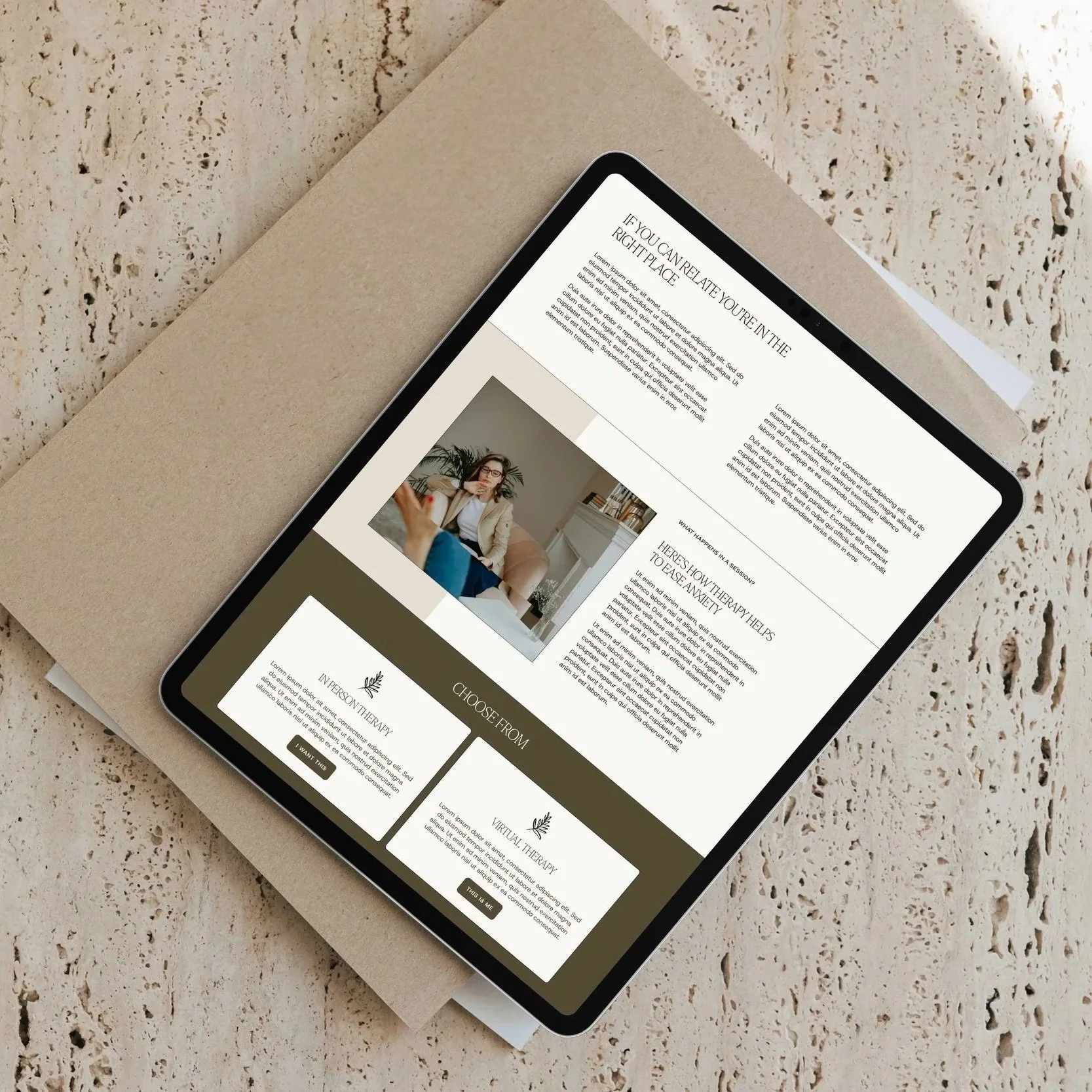 A tablet on a magazine displays a therapist's Squarespace website design, featuring calming images and welcoming text.