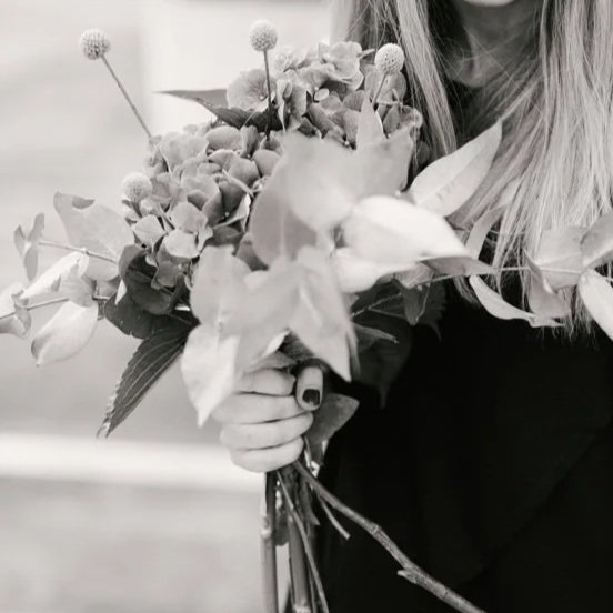 Person holding a bouquet of flowers
