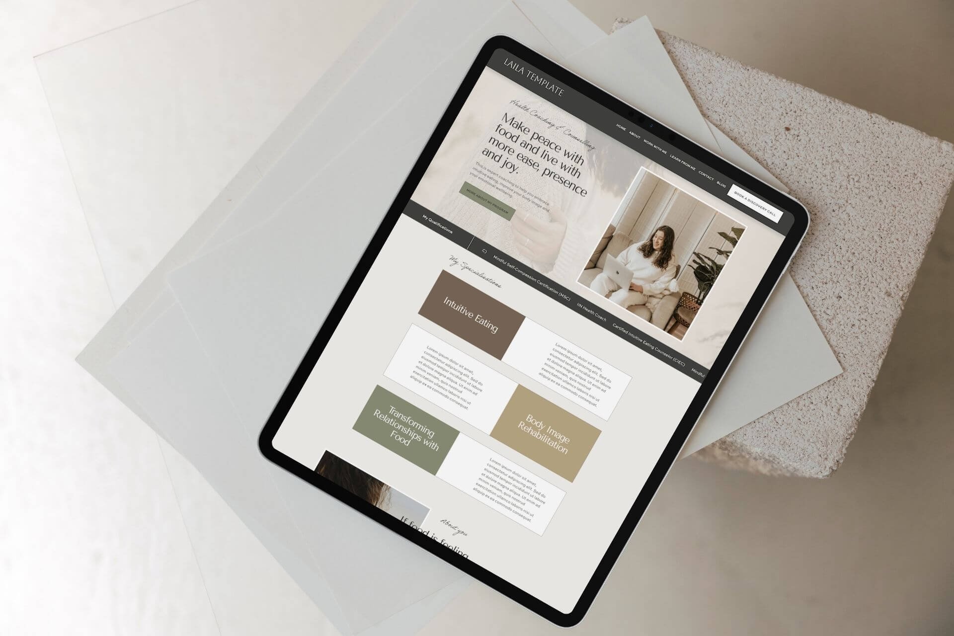 Tablet displays a Squarespace Website Template for Health Coach with a woman and autumnal colour content blocks.