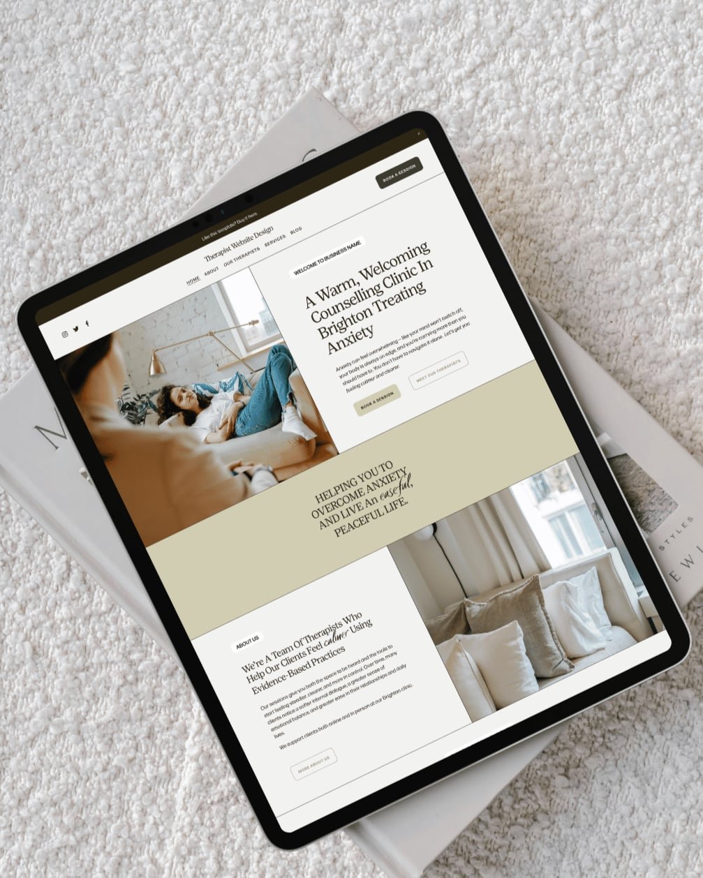 Tablet displaying a counseling clinic website, resting on a textured carpet and a closed magazine.