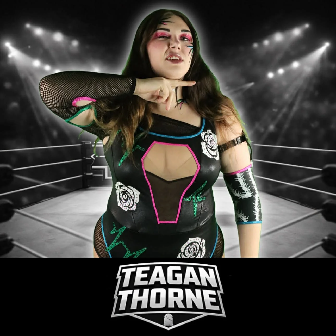 A woman dressed as a professional wrestler, standing in a wrestling ring with bright lights in the background. She is making a gesture with her hand and has colorful makeup and a custom wrestling outfit with rose and bandage graphics. The text "Teagan Thorne" is displayed at the bottom of the image.