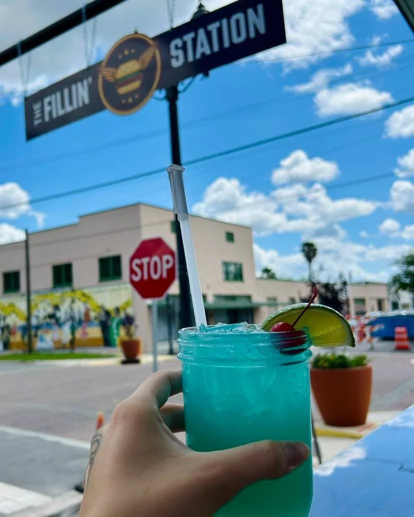 Signature blue cocktail served outside The Fillin' Station in historic downtown Palatka.