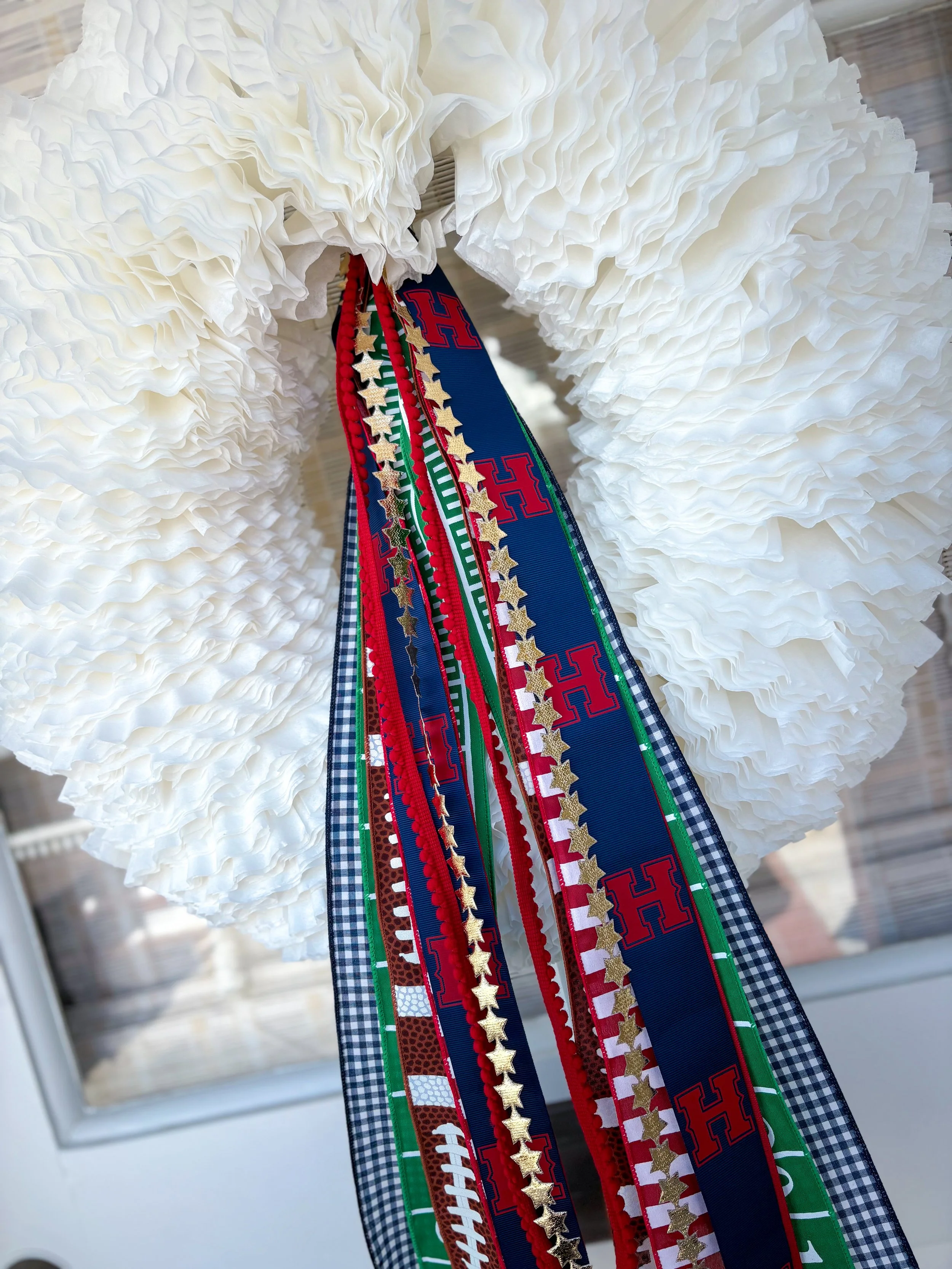 Hanging coffee filter white wreath with various ribbons featuring football and Texas Aggie themes.