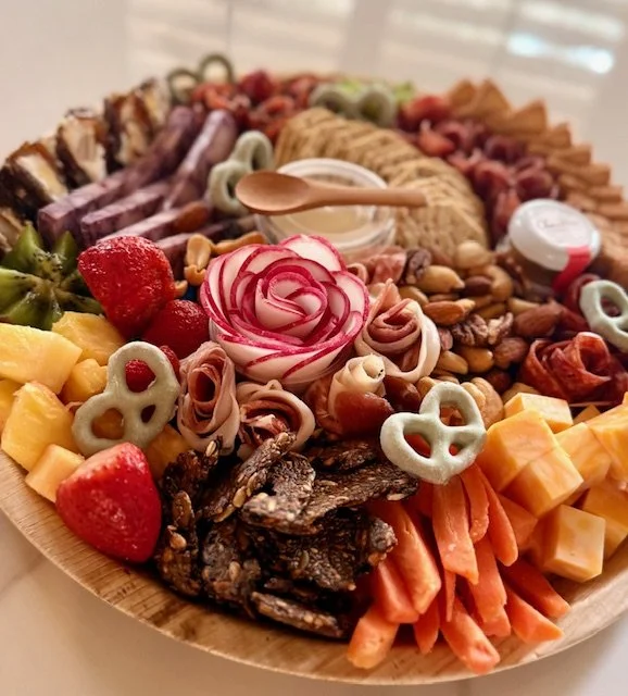 Medium charcuterie board with meats, cheeses, fruit, and crackers by Charcuterie Chic San Antonio