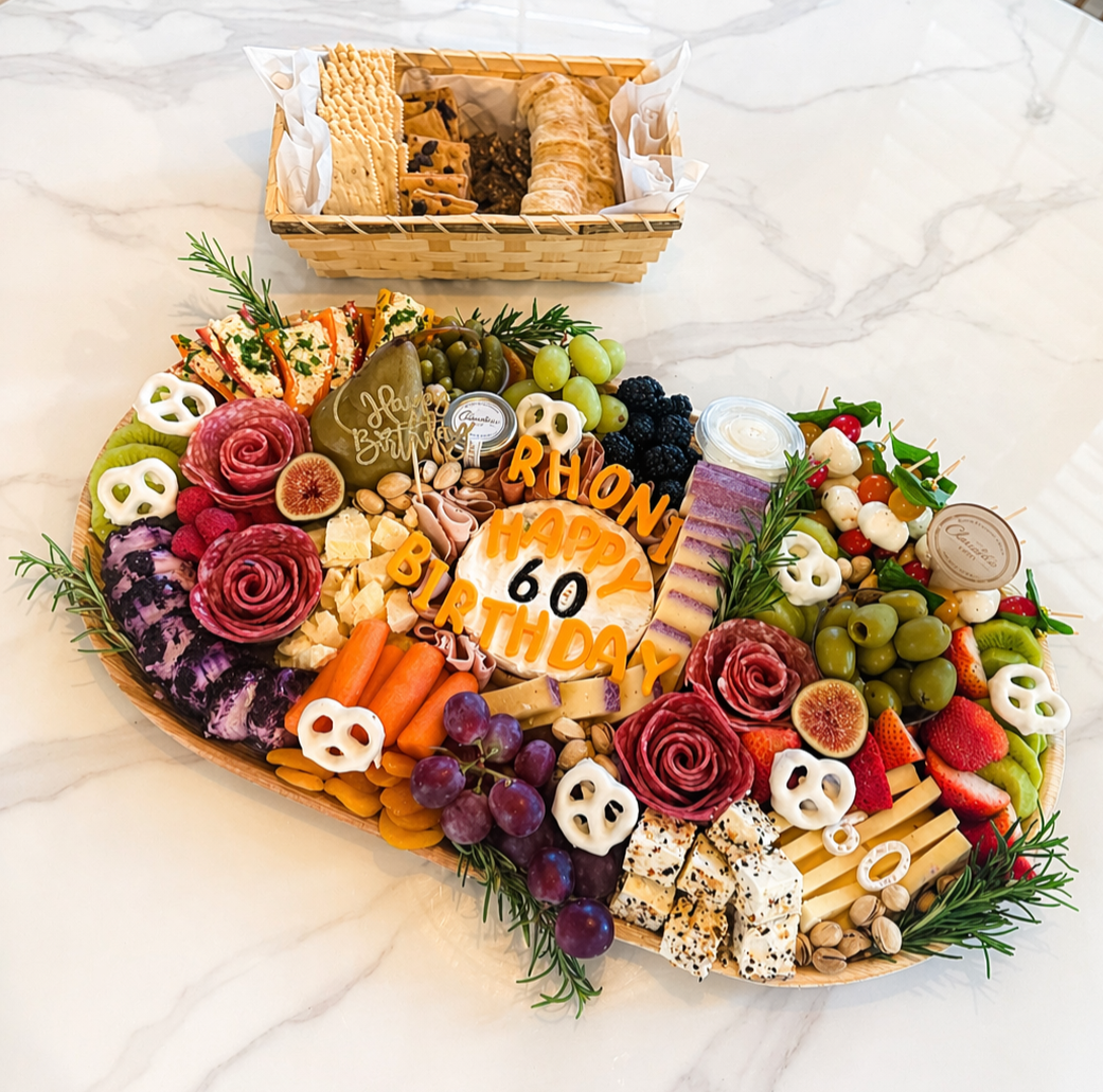 Custom birthday charcuterie board with artisan cheeses, cured meats, fresh fruit, vegetables, crackers, salami roses and personalized birthday details.