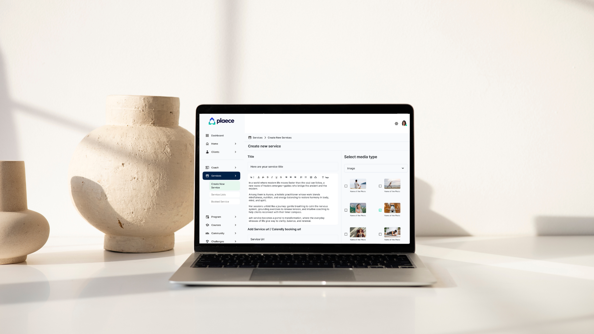 Laptop on white desk displaying a service creation webpage, two beige ceramic vases on left, plain white wall background.