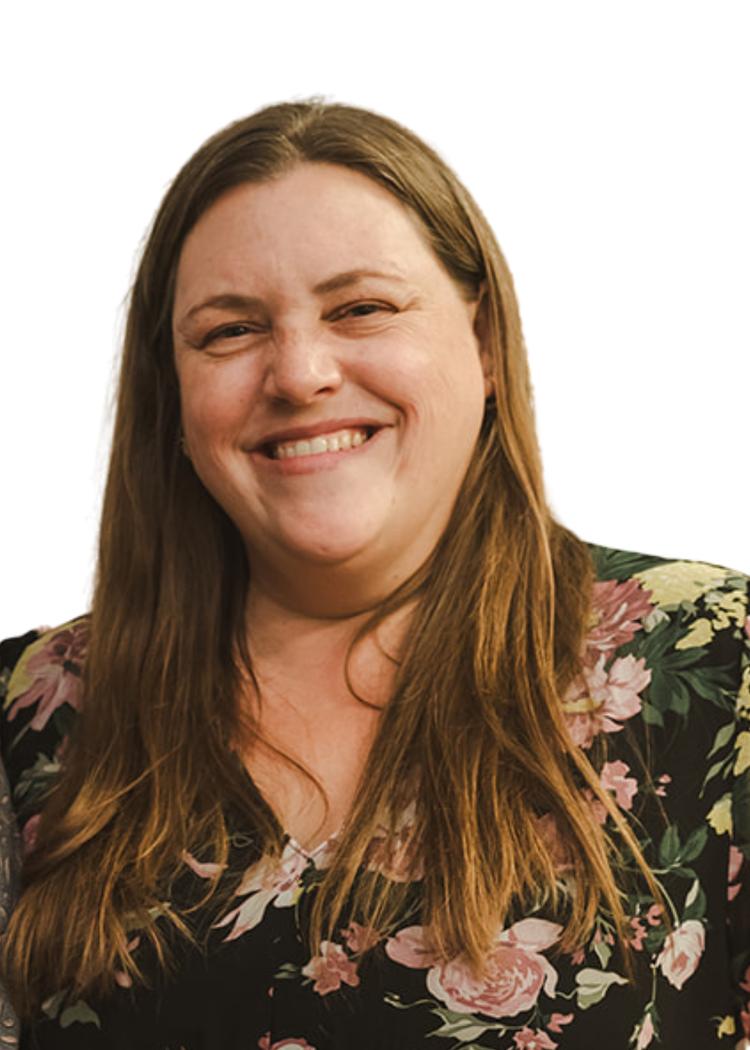 A smiling woman with long brown hair, wearing a floral blouse, against a plain white background.