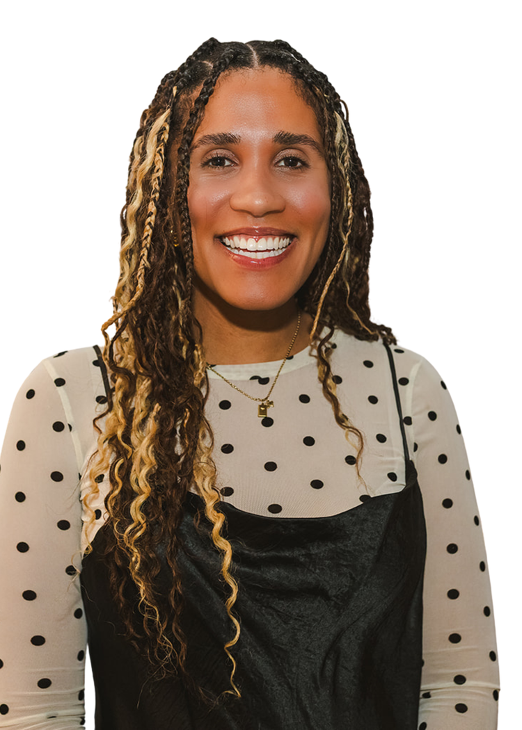 Smiling woman with multi-colored curly hair, wearing a polka dot top and a black dress, against a white background.