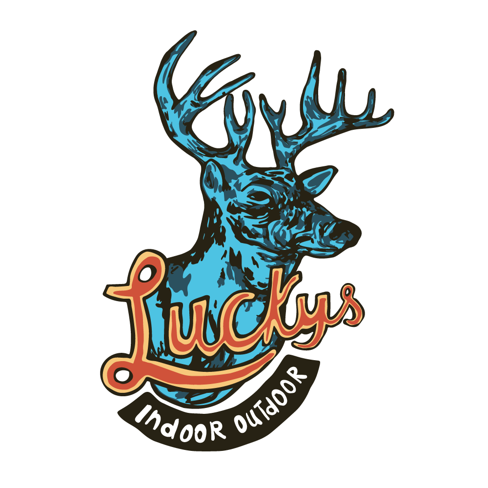 A logo featuring a blue and black illustration of a deer head with large antlers, with the text "Lucks" in stylized orange and cream lettering over the deer's neck, and the phrase "Indoor Outdoor" curved underneath in white on a black background.