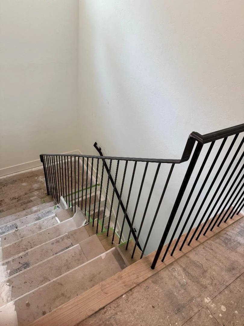 This staircase railing follows the natural slope of the stairs for a smooth, cohesive look. Its straightforward design keeps the stairway functional without feeling heavy.
