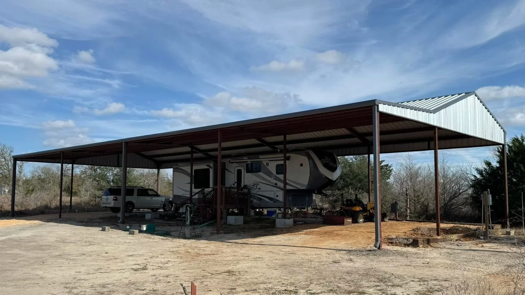 This custom RV cover features a 26' × 100' main structure with a 4/12 roof pitch and a 14' lean-to with a 2/12 pitch, providing extended coverage and protection for RV parking and equipment storage. 