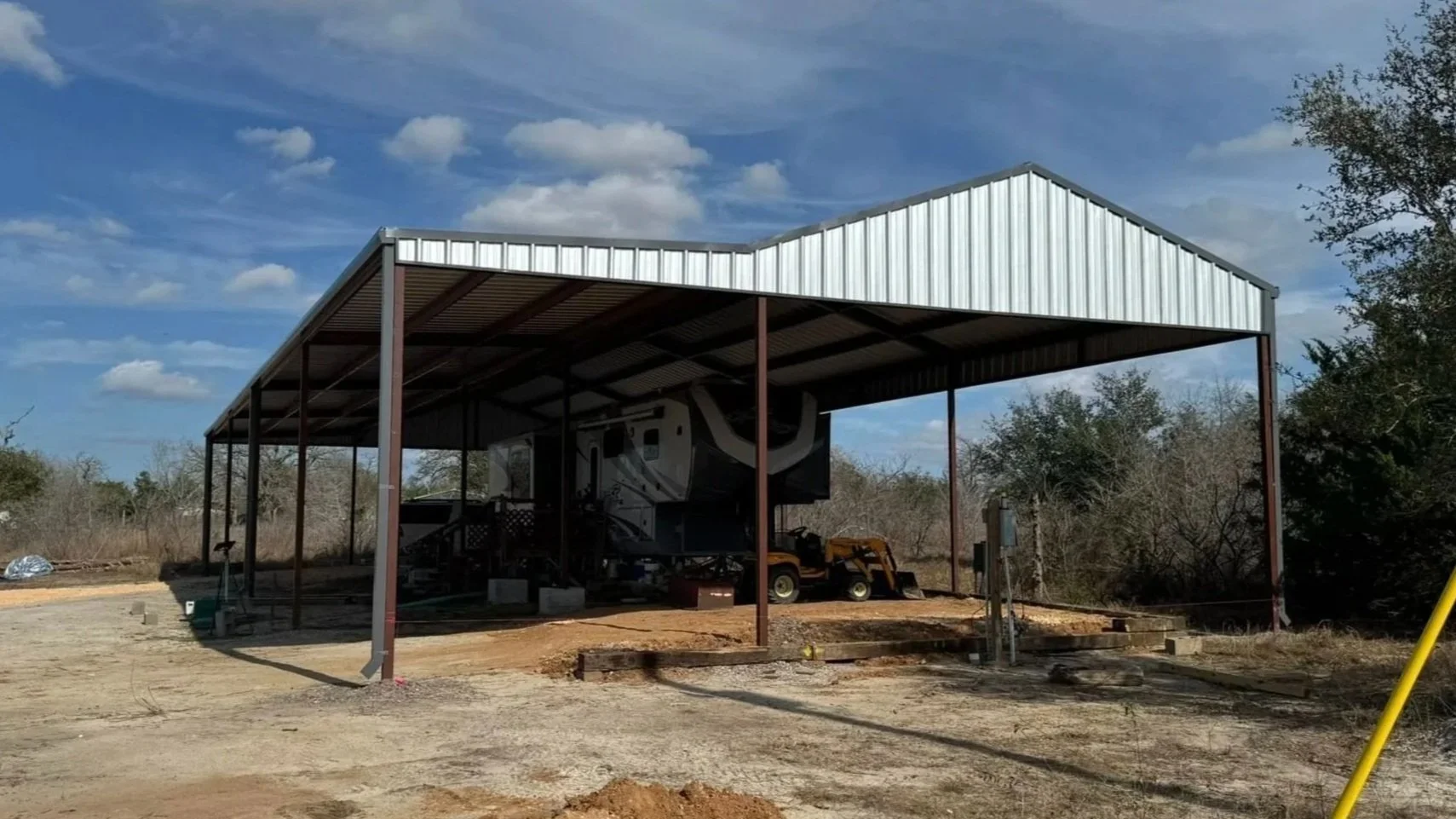 This custom RV cover features a 26' × 100' main structure with a 4/12 roof pitch and a 14' lean-to with a 2/12 pitch, providing extended coverage and protection for RV parking and equipment storage. 