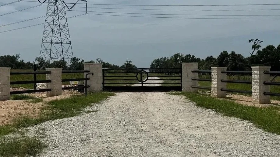 This custom entrance features brick columns paired with a 16' sliding gate for a clean, timeless look. The combination of masonry and steel provides both durability and visual appeal. 