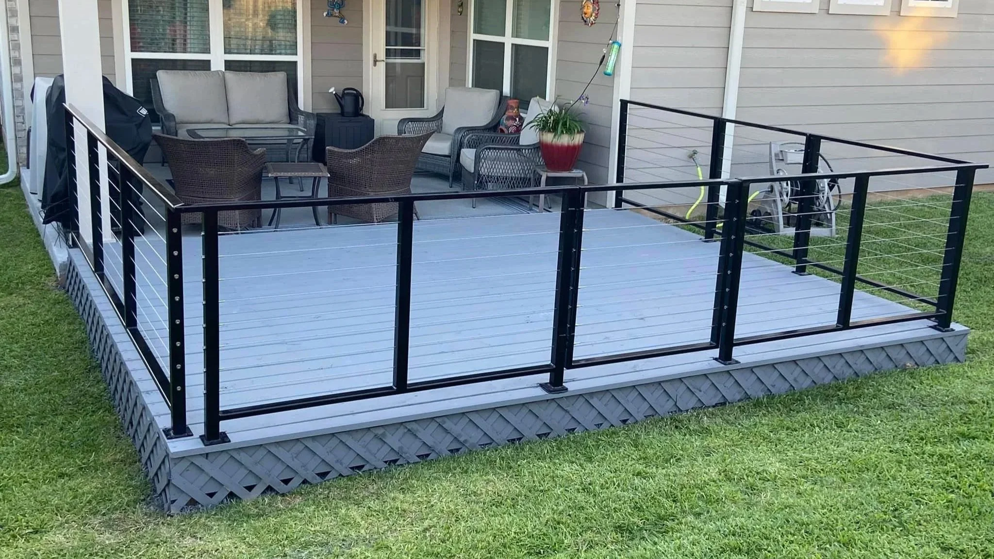 This deck cable railing combines sleek posts with horizontal cable infill for a modern outdoor finish. The open layout keeps the deck feeling spacious and unobstructed.