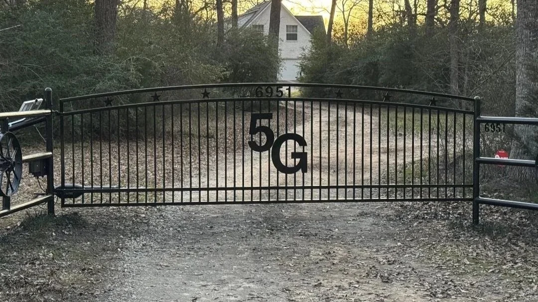 This custom 16' entrance gate features a simple, timeless design that complements its surroundings. Its sturdy construction ensures dependable performance and ease of use.