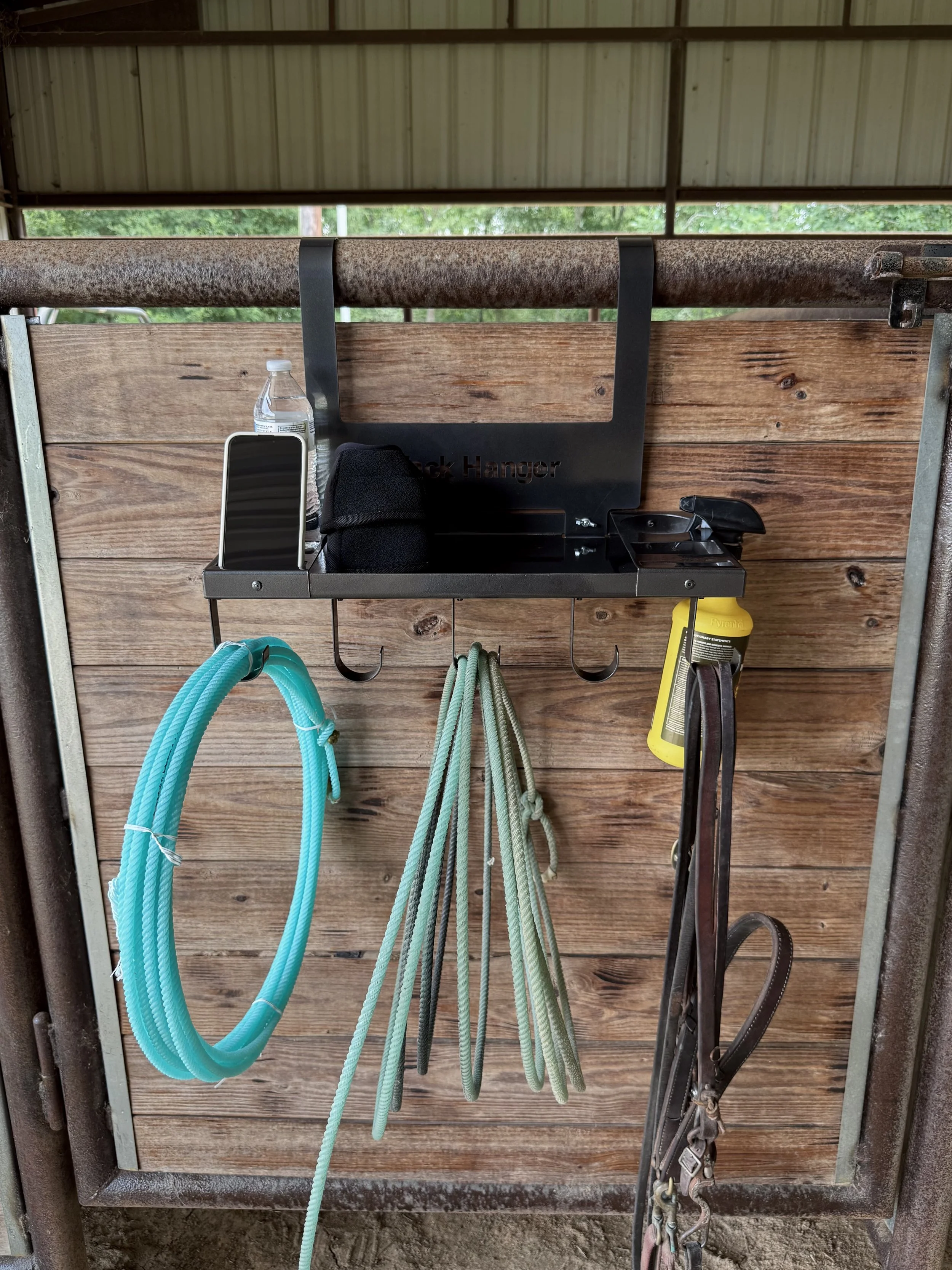 Original Tack Hanger Organizing Ropes, Tack, and Ranch Gear on a Stall Panel with Built-In Storage Tray.