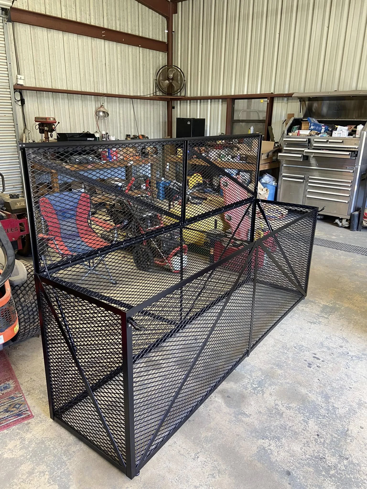 This trash can cage is designed to keep wildlife out while securely containing waste bins. The sturdy enclosure helps maintain a clean, organized area. 
