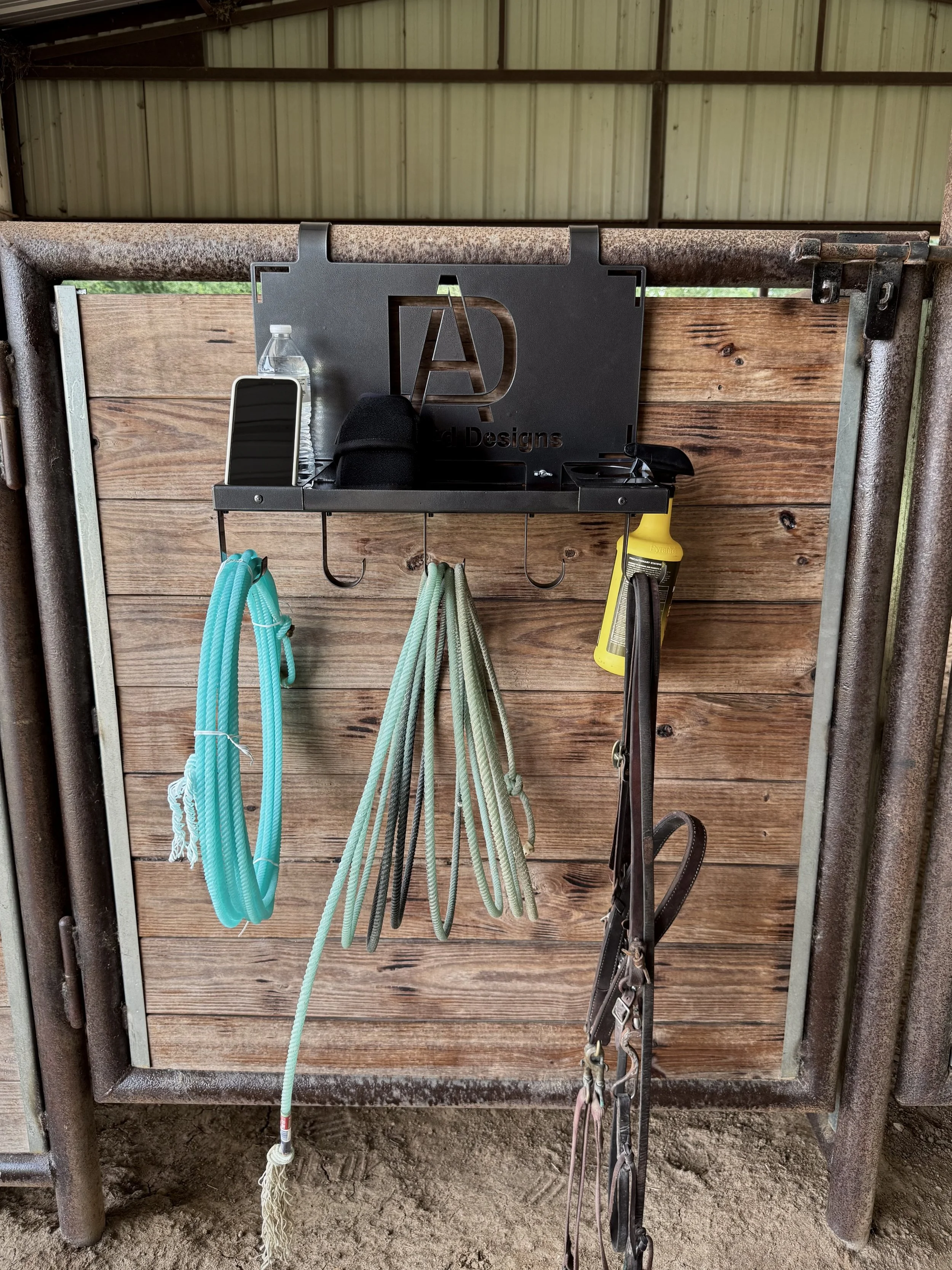 Custom Metal Tack Hanger Mounted on a Pipe Organizing Ropes, Tack, and Ranch Gear.