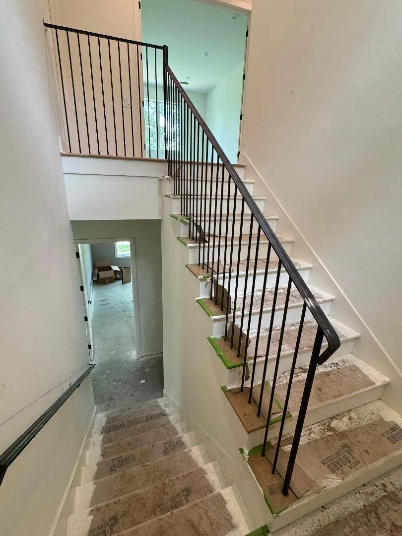 This staircase railing follows the natural slope of the stairs for a smooth, cohesive look. Its straightforward design keeps the stairway functional without feeling heavy.