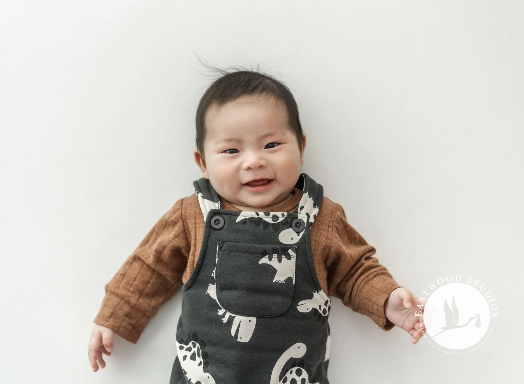 smiling baby boy during his Petit Fours Mini Milestone session in Christchurch studio